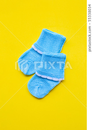Baby socks on yellow background. Baby socks on yellow background. 55338034
