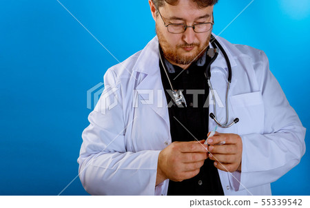 doctor with a syringe in his hand and in a suit doctor with a syringe in his hand and in a suit 55339542