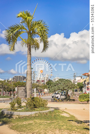 Red iron bridge passing through the river of American village in Chatan town and Ferris wheel in Mihama Carnival Park 55341061