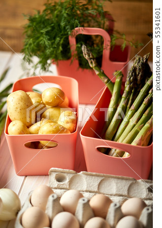 Fresh asparagus potatoes and eggs on white  kitchen table 55341601