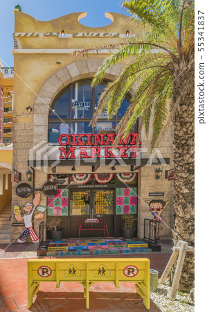 A yellow bench decorated with cute street art in the American village of Chatan town. A yellow bench decorated with cute street art in the American village of Chatan town. 55341837