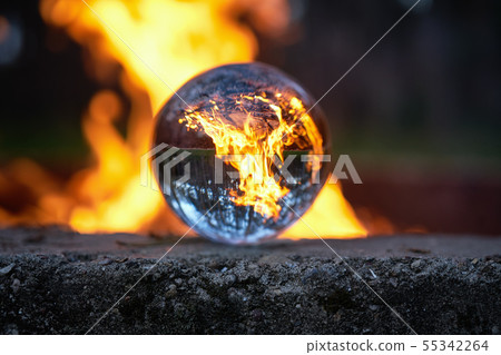 Upside down view through the lensball on blurred campfire in forest 55342264