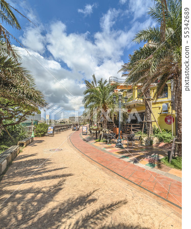 A distortion seaside building standing on a palm-lined beach near the American Village in Okinawa 55342689