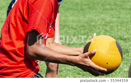 Athlete catching a medicine ball Athlete catching a medicine ball 55344359