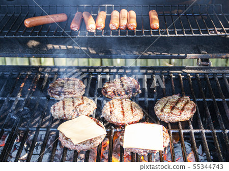 Grilling hot dogs and hamburgers Grilling hot dogs and hamburgers 55344743