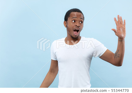 Half-length close up portrait of young man on blue background. Half-length close up portrait of young man on blue background. 55344770