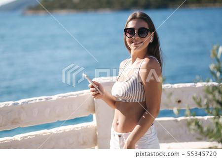 Young sport woman use wireless headphones for listening music until she running in the morning on 55345720