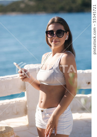 Young sport woman use wireless headphones for listening music until she running in the morning on 55345721