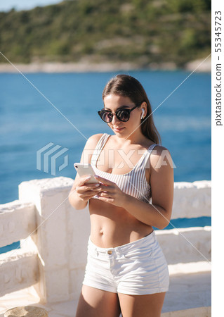 Young sport woman use wireless headphones for listening music until she running in the morning on 55345723