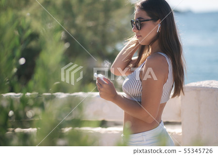 Young sport woman use wireless headphones for listening music until she running in the morning on Young sport woman use wireless headphones for listening music until she running in the morning on 55345726