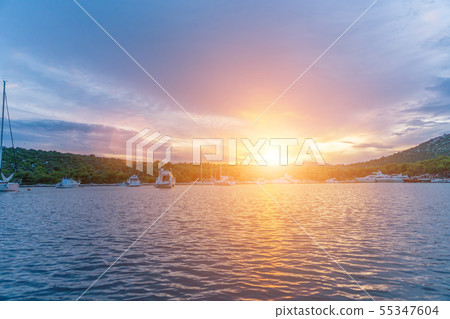 calm bay at evening with moored yachts 55347604