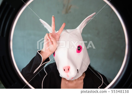 Girl with rabbit mask with v sign 55348138