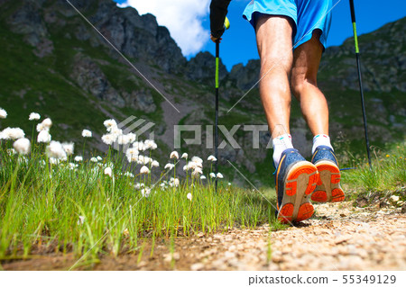 Detail of strong mountain walker on trail Detail of strong mountain walker on trail 55349129