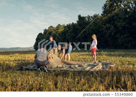 Family set up tent camp at sunset, beautiful 55349860