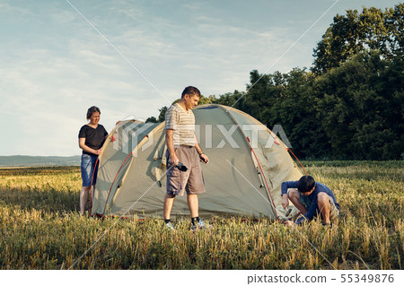 Family set up tent camp at sunset, beautiful Family set up tent camp at sunset, beautiful 55349876