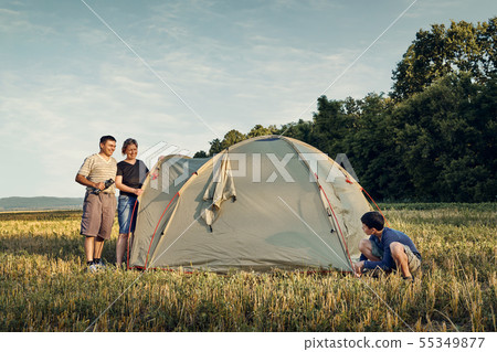 Family set up tent camp at sunset, beautiful Family set up tent camp at sunset, beautiful 55349877