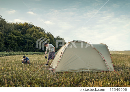 Family set up tent camp at sunset, beautiful Family set up tent camp at sunset, beautiful 55349906
