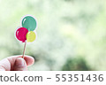 Hand holding colorful paper balloons 55351436