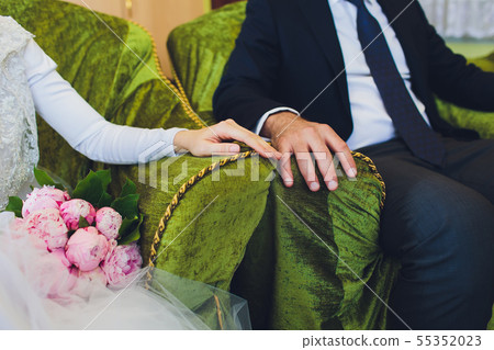 Muslim wedding rite. Bride and groom sitting on the floor in the moqsue. Muslim Wedding prayers 55352023