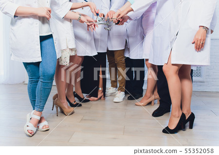 legs of women in medical coats on a white background. 55352058