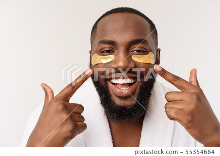 A young man with paper eyes mask on face looking shocked with an open mouth, isolated on a white 55354664