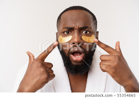 A young man with paper eyes mask on face looking shocked with an open mouth, isolated on a white 55354665