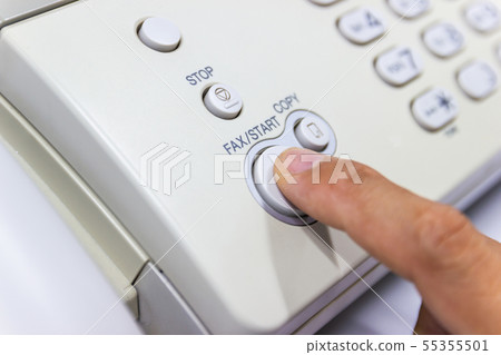hand man are using a fax machine in the office 55355501