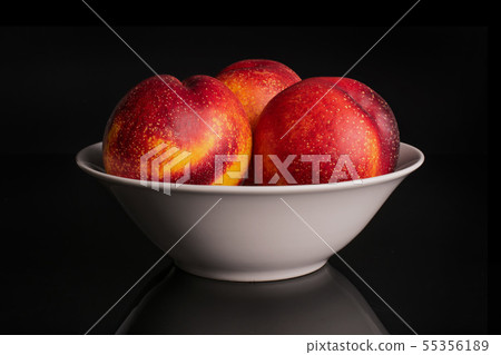 Fresh red nectarine isolated on black glass 55356189