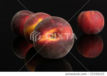Fresh red peach isolated on black glass 55356325