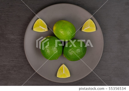 Fresh green lime on grey stone Fresh green lime on grey stone 55356534