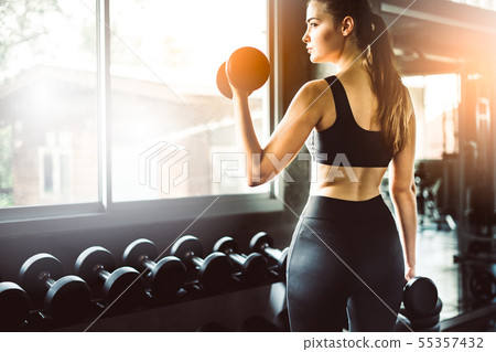 Young girl playing dumbbell to exercise in 55357432