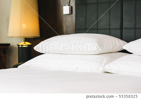 Beautiful luxury comfortable white pillow and blanket on bed with light lamp 55358325