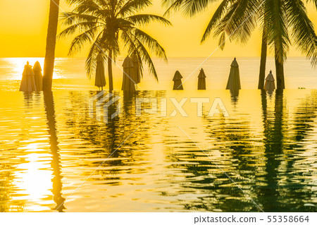 Beautiful outdoor tropical nature landscape of swimming pool in hotel resort with coconut palm tree umbrella and chair nearly sea ocean beach Beautiful outdoor tropical nature landscape of swimming pool in hotel resort with coconut palm tree umbrella and chair nearly sea ocean beach 55358664