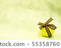 Tennis ball with Christmas ribbon on yellow backgr 55358760