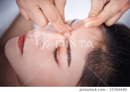 woman undergoing acupuncture treatment on head woman undergoing acupuncture treatment on head 55360490