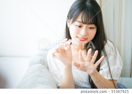 Young girl doing nails 55367925