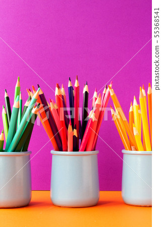 Colored pencils on purple background. 55368541