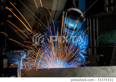 Industrial worker is welding repair steel part  55374331
