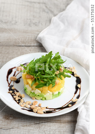 Salad with avocado, mango and mozzarella Salad with avocado, mango and mozzarella 55375032