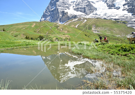 "Kleine Scheidegg-Wengern Alp" Eiger reflecting in the pond on the way of the hiking course 55375420