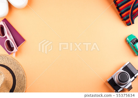 Travel items flat lay on orange with camera Travel items flat lay on orange with camera 55375634