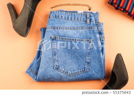 Fashion flat lay with jeans on orange Fashion flat lay with jeans on orange 55375643
