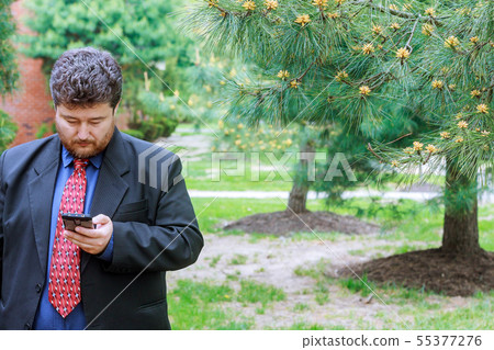 Businessman looking into the phone, man working on Businessman looking into the phone, man working on 55377276