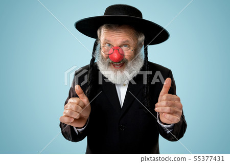 Portrait of an senior jewish man celebrating red nose day 55377431