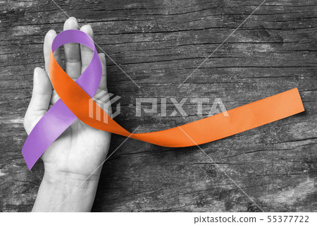 Orchid Orange Awareness ribbon symbolic on hand Orchid Orange Awareness ribbon symbolic on hand 55377722