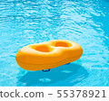 Yellow rubber ring floating in the pool 55378921