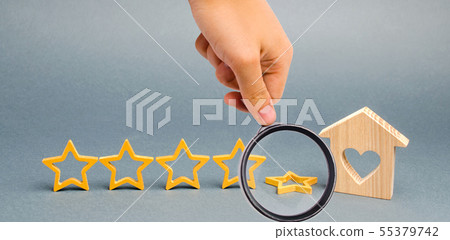 The fall fifth star near a miniature wooden house. The fall fifth star near a miniature wooden house. 55379742