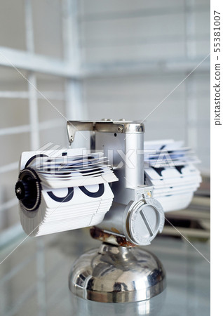 Classic flip clock on a metal stand in the interior.The theme of time and punctuality. Classic flip clock on a metal stand in the interior.The theme of time and punctuality. 55381007