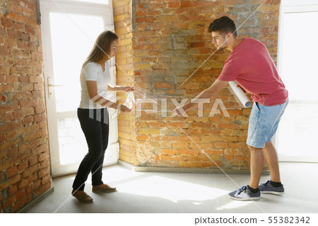 Young couple doing apartment repair together themselves Young couple doing apartment repair together themselves 55382342