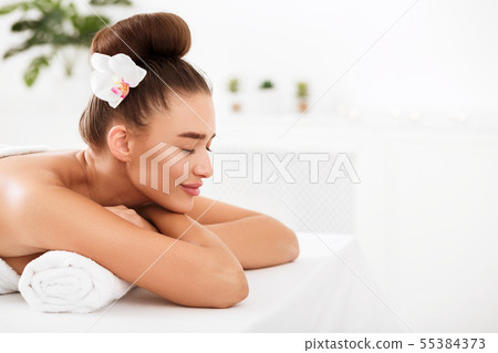 Beautiful woman relaxing at spa salon, copy space Beautiful woman relaxing at spa salon, copy space 55384373